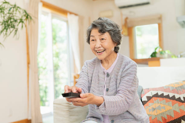 istock Senior women watching television at home. 2157132007