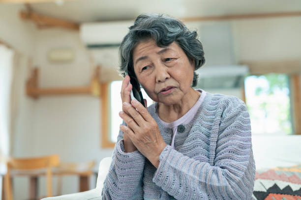 Senior woman anxiously making a phone call.