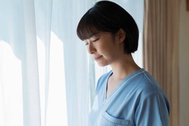 istock Window sill Depressed-looking female health care worker. 2157133317