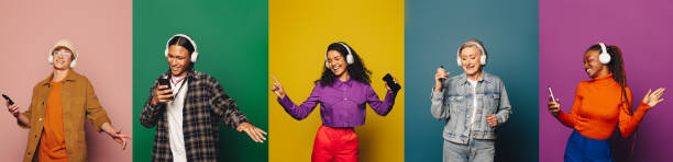 istock Diverse group enjoying music, dancing against colorful backgrounds 2157133834