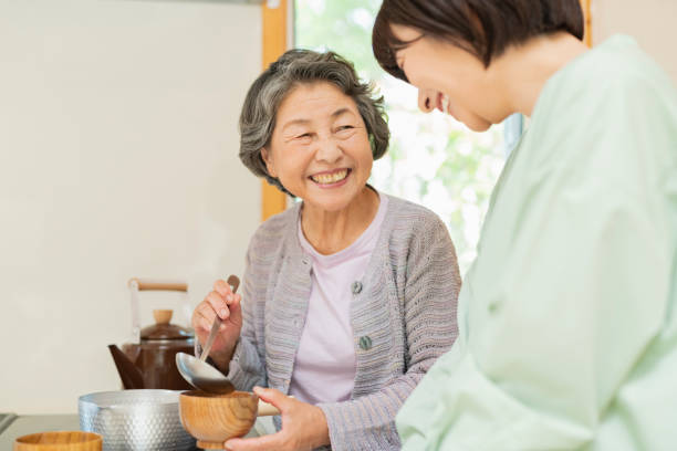 istock Grandson learning to cook from his grandmother. 2157134149