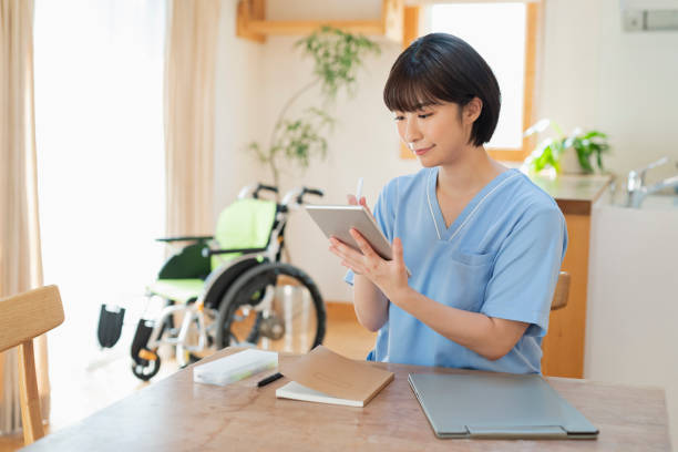 istock Female health care worker writing a logbook on a tablet. 2157134568