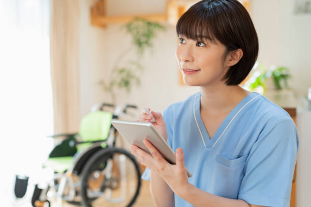 istock Female health care worker writing a logbook on a tablet. 2157134606