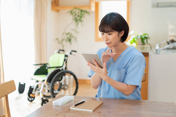 istock Female health care worker writing a logbook on a tablet. 2157134616