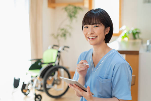 istock Female health care worker writing a logbook on a tablet. 2157134663