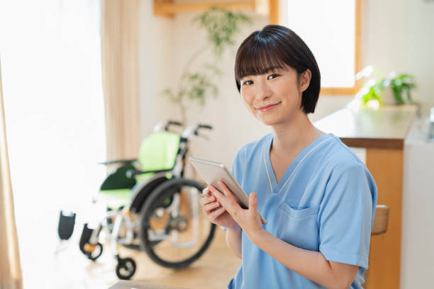 istock Female health care worker writing a logbook on a tablet. 2157134675