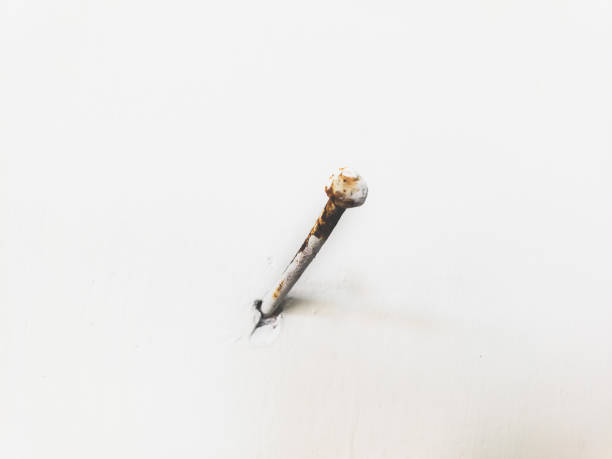 istock rusty nails stuck to the white walls 2157134980