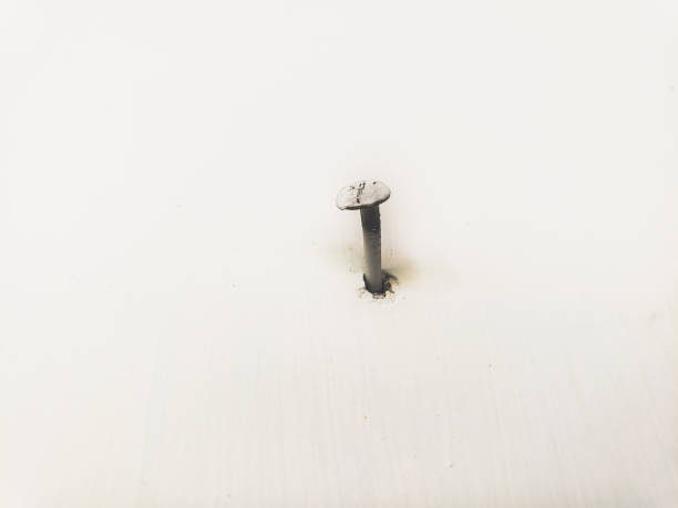istock rusty nails stuck to the white walls 2157134994