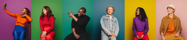 istock Group of people posing and smiling playfully against colorful backgrounds while taking selfies 2157135363