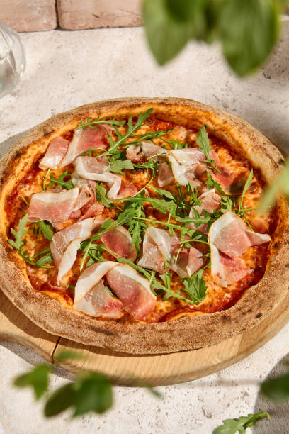 istock Summer Delight Fresh Pizza with Parma Ham and Arugula in Sunlit Setting 2157135537
