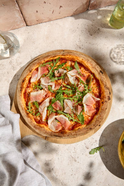istock Sunlit Summer Pizza with Parma Ham and Arugula - Fresh and Rustic Italian Delight 2157135560