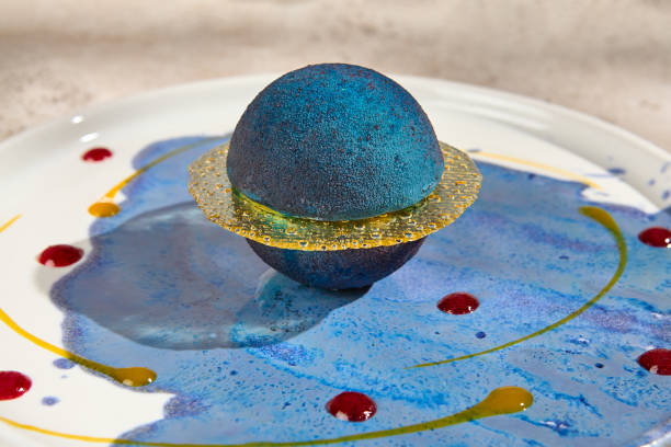 istock Galaxy-Inspired Mousse Cake in Planet Shape with Summer Sunlight and Shadow Play 2157135615