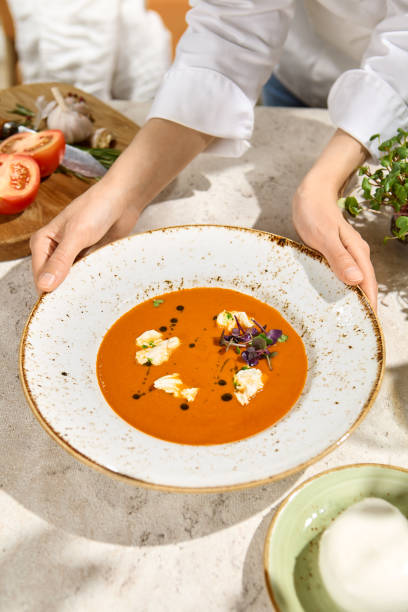 istock Sunlit Tomato Soup with Burrata Cheese - Summer Dining in Natural Light and Shadow 2157135633