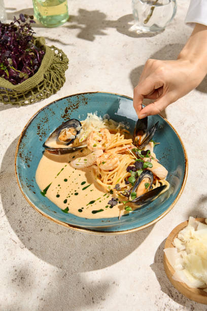 istock Seafood Pasta in Creamy Sauce with Summer Sunlight and Shadow - Gourmet Dining Experience 2157135668