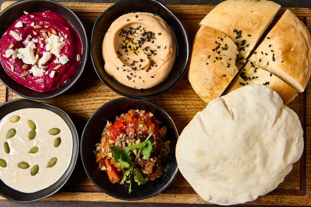 istock Assorted Mezze Platter with Pita and Flatbread Featuring Hummus, Beet Hummus, Adjapsandali, and Tonnato Sauce 2157135716