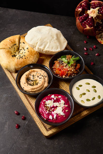 istock Assorted Mezze Platter with Pita and Flatbread Featuring Hummus, Ajapsandali, Beet Hummus, and Tonnato Sauce 2157135728