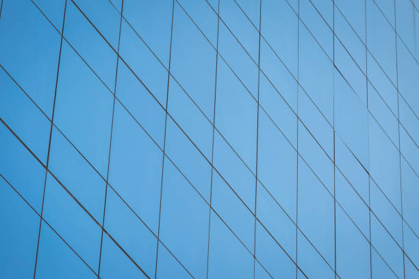 Modern office building with blue glass windows background