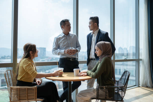 istock Asian multiracial coworkers enjoy communication during coffee break in office cafeteria 2157140083