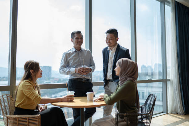 istock Asian multiracial coworkers enjoy communication during coffee break in office cafeteria 2157140084