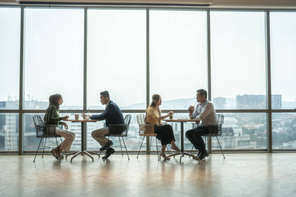 istock Group of Asian coworkers discussing in modern office with window background 2157140099