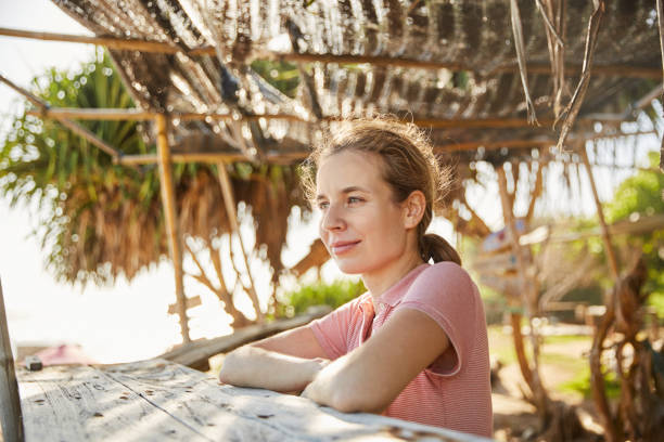 istock Young woman on the ocean shore 2157140181