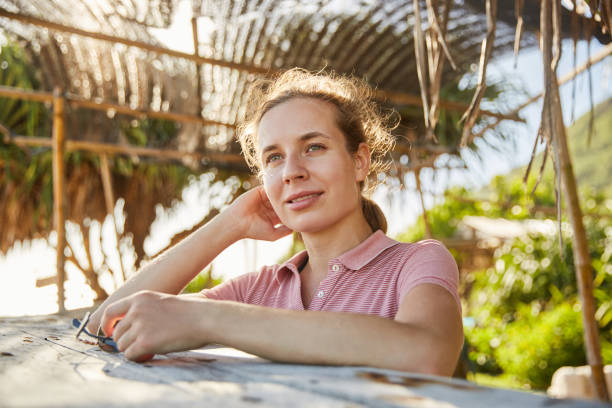 istock Young woman on the ocean shore 2157140195