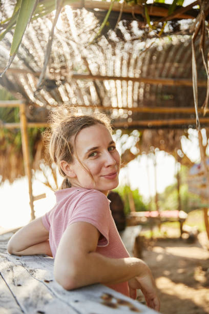 istock Young woman on the ocean shore 2157140202
