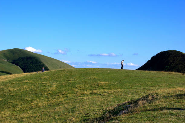 istock view of a green meadow against two peaks 2157141145