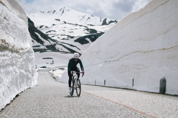 istock Road biker rides up high mountain pass 2157142123