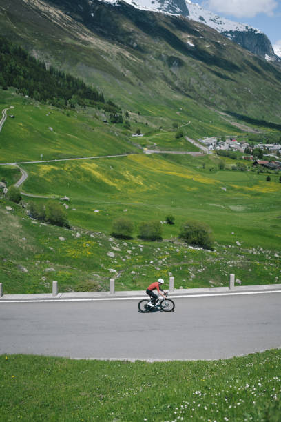 istock Road biker rides up high mountain pass in springtime 2157142518