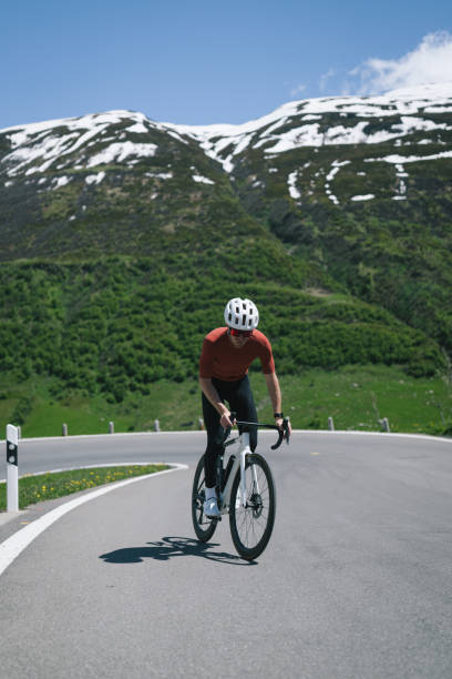 istock Road biker rides up high mountain pass in springtime 2157142519