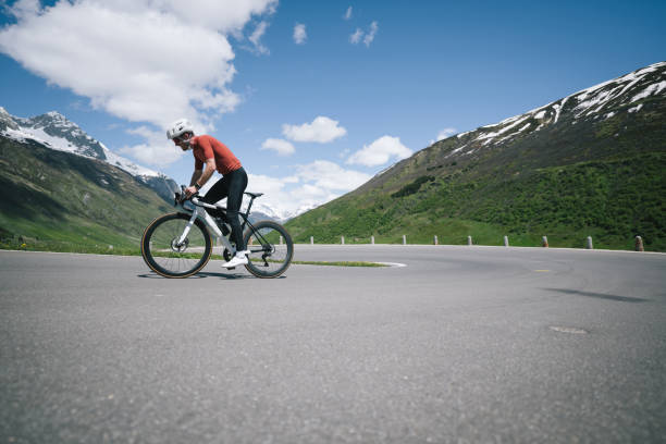 istock Road biker rides up high mountain pass in springtime 2157142684