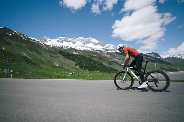 istock Road biker rides up high mountain pass in springtime 2157142688
