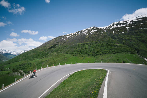 istock Road biker rides up high mountain pass in springtime 2157142690