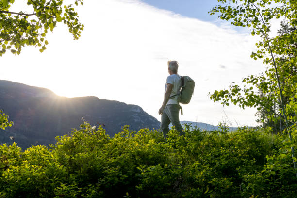 istock Backpacker watches sunrise in mountain meadow 2157143915