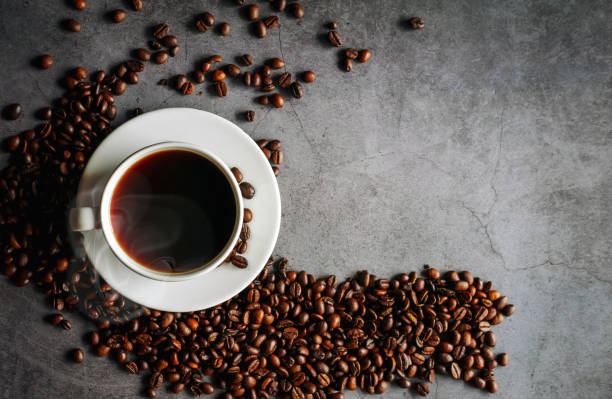 istock Overhead view of black coffee cup aromatic . Coffee cup and coffee beans on  gray background 2157145963