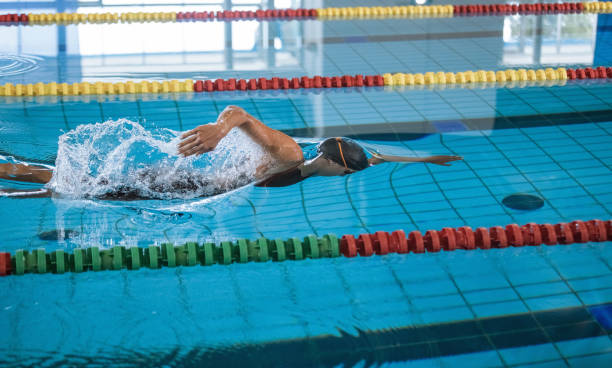 istock Professional female swimmer swimming the front crawl stroke 2157147149