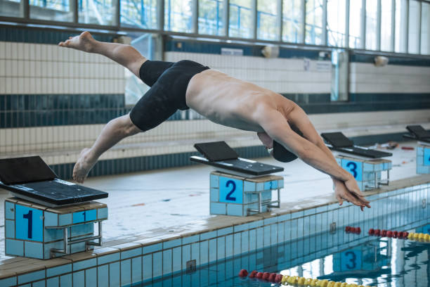 istock Swimmer jumping off the starting block 2157147208