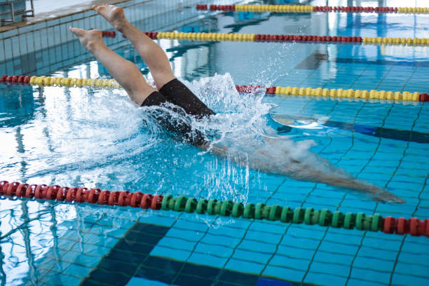 istock Swimmer jumping off the starting block 2157147666