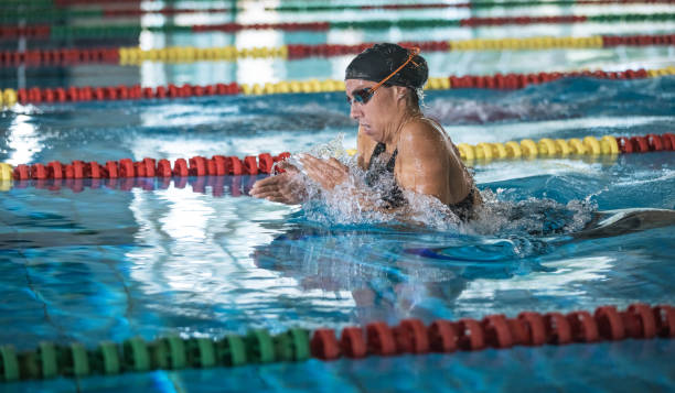 istock Powerful female swimmer swimming breaststroke at speed 2157147744