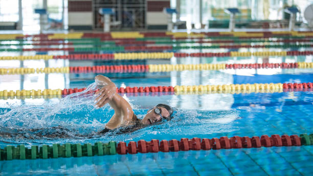 istock Professional female swimmer swimming the front crawl stroke 2157147780