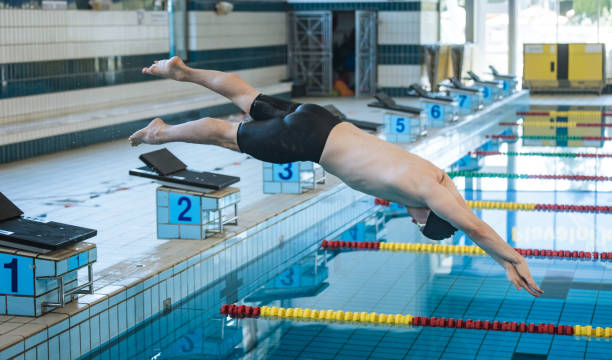 istock Swimmer jumping off the starting block 2157147864