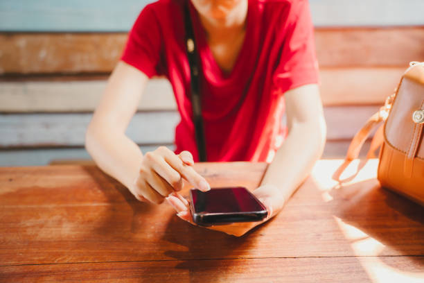 istock A woman in a red shirt is using a smartphone. 2157148182