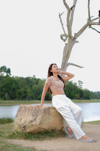 istock Young Asian woman playing under the tree 2157149771