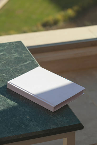 istock blank book mockup on green marble stone coffee table , shadow overlay 2157151097