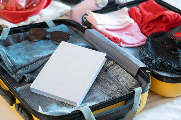 istock opened packed suitcase on bed in hotel room 2157151562