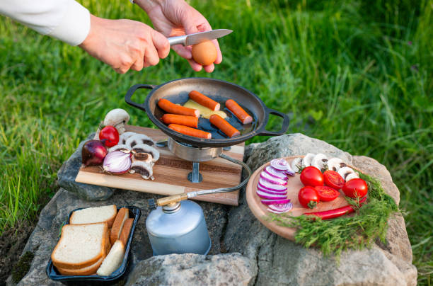 istock Cooking food in a frying pan while camping. 2157152071