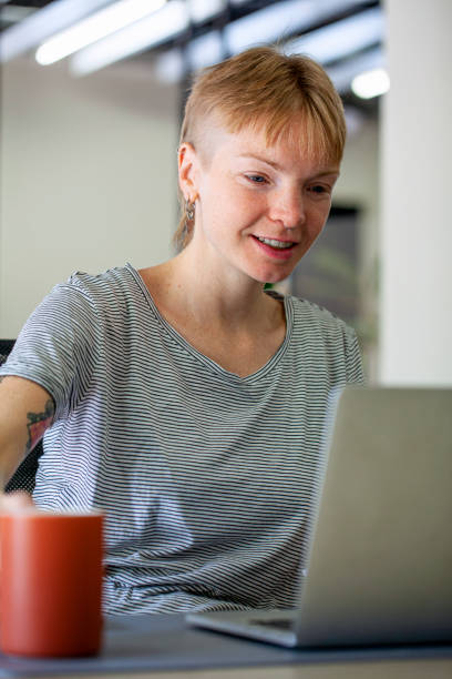 istock Young female entrepreneur working on laptop at shared workspace 2157153803