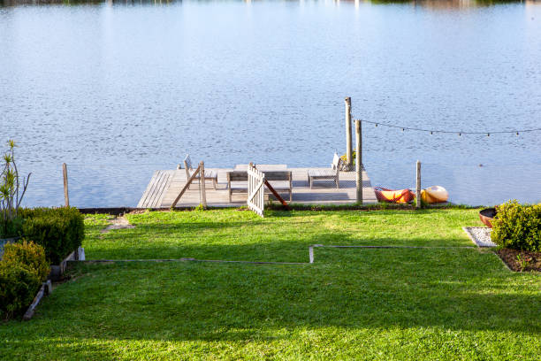 Medium shot view of house's backyard garden lawn facing lake