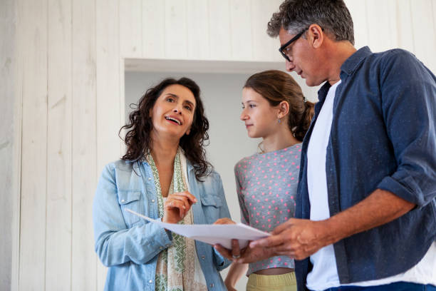 istock Family looking at blueprints for home renovation project 2157154288
